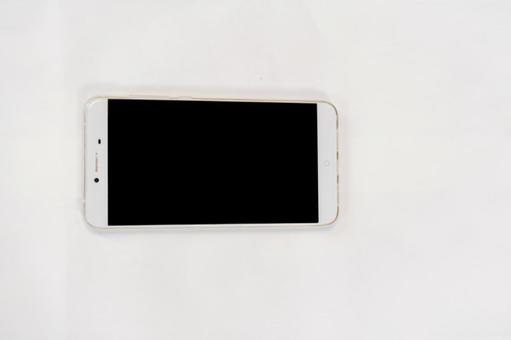 横向きにおいたスマートフォン スマートフォン,画面,黒画面の写真素材