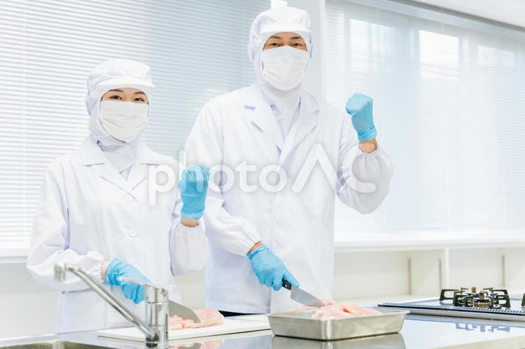 食品加工の仕事をする男女（ガッツポーズ） 食品加工,精肉加工,肉の写真素材