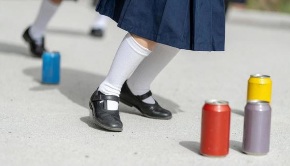 昔の遊び 缶蹴り遊びをする女の子 昔の遊び 缶蹴り遊びをする女の子の写真
