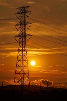 Electricity transmission tower illuminated by the setting sun, JPG