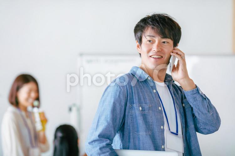 スマホを持つカジュアルな服装のビジネスマン スマートフォン,スマホ,システムエンジニアの写真素材