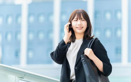 スマホで話す笑顔の女性・ビジネスウーマン スマホで話す笑顔の女性・ビジネスウーマン 女性,スマホ,夏の写真素材