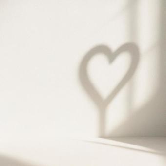 窓辺の光で小物からできたハート型の影の写真