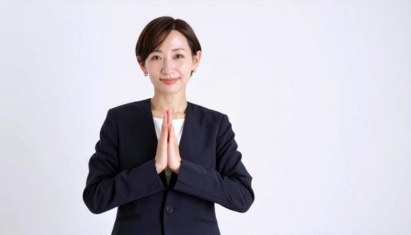 両手をあわせてお願いするビジネスウーマン 両手をあわせてお願いするビジネスウーマンの写真