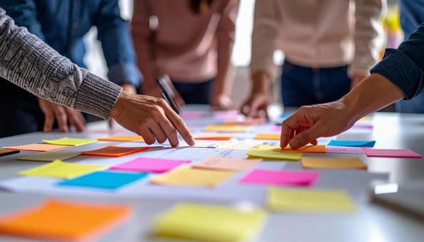 付箋を置いて会議するビジネスパーソンの写真