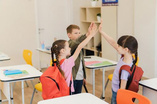 ハイタッチする生徒たちの横顔 男の子,女の子,子どもの写真素材