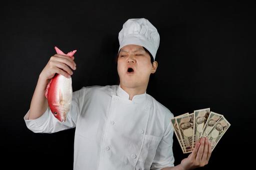 魚とお金を持つシェフ 魚とお金を持つシェフの写真