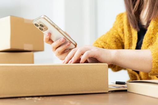 荷物の発送準備をする女性 配送,配達,段ボールの写真素材