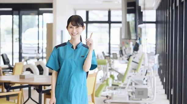 介護施設で指差しをするアジア人介護福祉士 介護施設で指差しをするアジア人介護福祉士 介護福祉士,介護士,指差しの写真素材