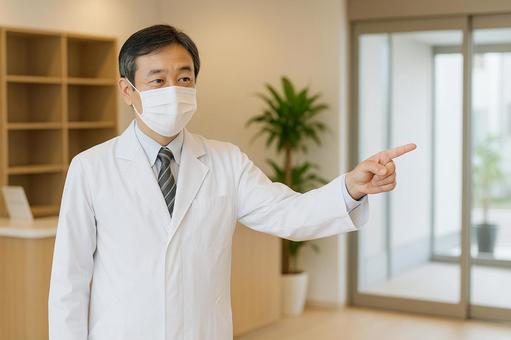 指差す男性医師 指差す男性医師の写真