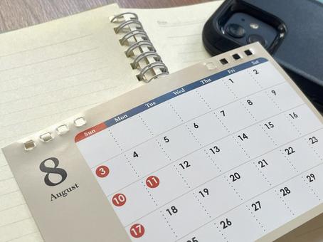 A notebook and an August calendar on a student's desk, JPG