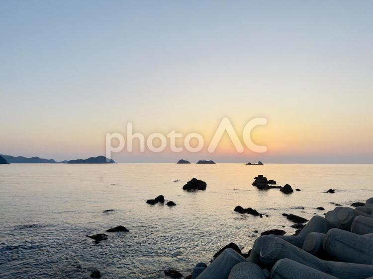 夕焼けの水平線と防波堤の影 風景,海,夕日の写真素材