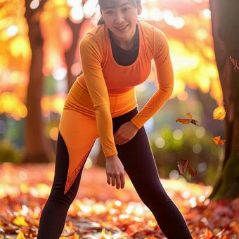 スポーツの秋 紅葉の中でストレッチ 女性 スポーツの秋 紅葉の中でストレッチ 女性の写真