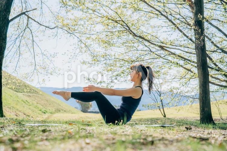 屋外でヨガをする女性（舟のポーズ） ヨガ,ダイエット,ピラティスの写真素材