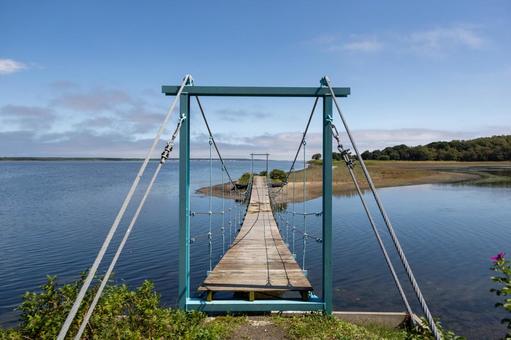鶴沼に架かる吊り橋と青空 アッケシソウ群落,紋別,湧別の写真素材