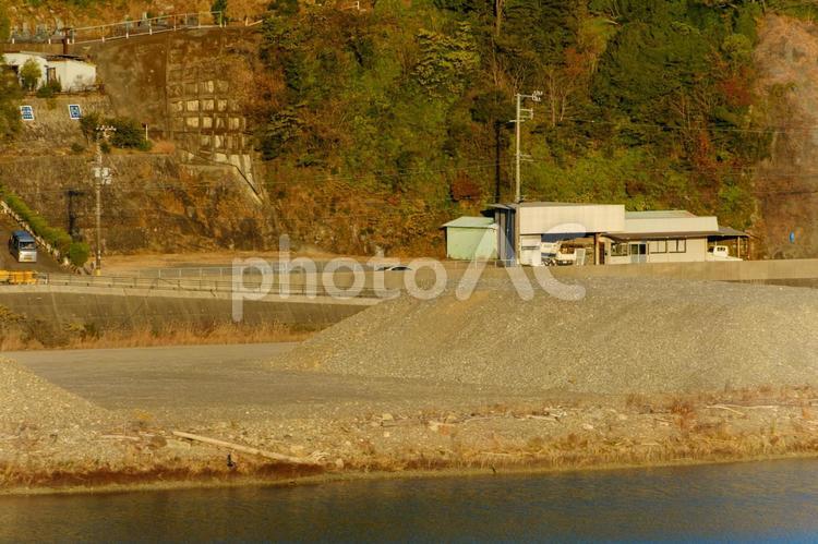 川沿いの資材置き場と小さな建物 資材置き場,建物,小屋の写真素材