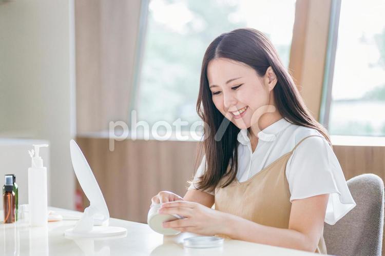 鏡の前でメイクする女性（クリーム） 保湿,スキンケア,クリームの写真素材