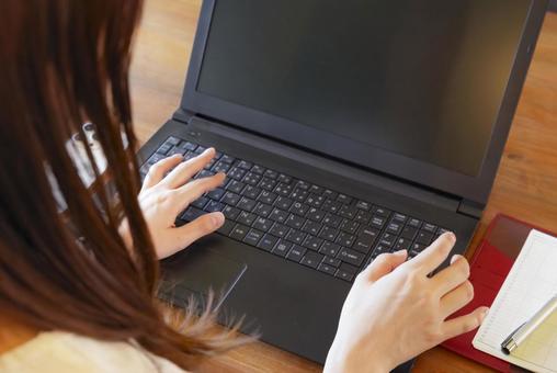 Hands of a woman working on a laptop, JPG