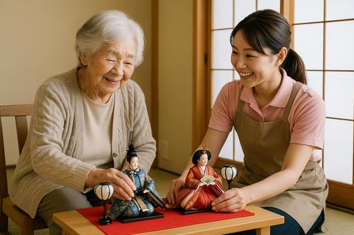 ひな人形を飾る介護士 ひな人形を飾る介護士の写真
