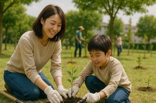公園で木を植える親子の写真