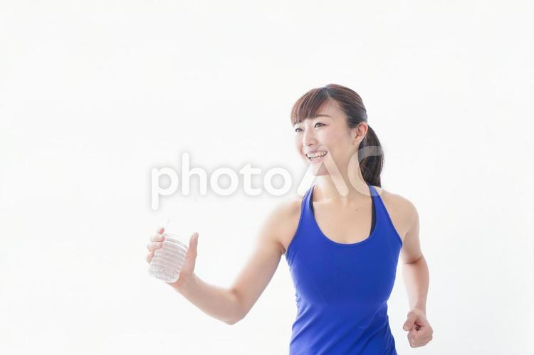 水分を摂取するスポーツウェアの女性 ストレッチ,リラックス,水分不足の写真素材