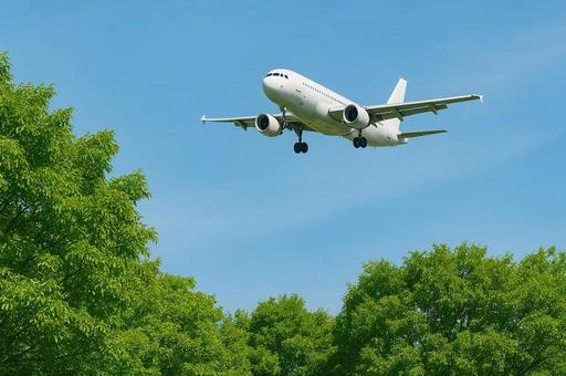 青空を飛ぶ飛行機・旅客機と新緑・旅行 青空を飛ぶ飛行機・旅客機と新緑・旅行の写真