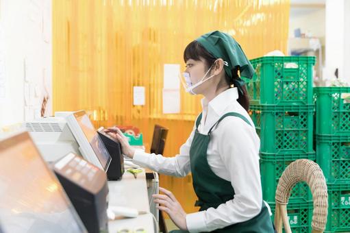 スーパーの裏方で働く人々 値札ラベル作成 スーパーの裏方で働く人々 値札ラベル作成 スーパー,スーパーマーケット,バックヤードの写真素材