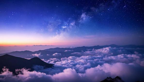 Mysterious sea of clouds: mist covering the mountains and a sky full of stars, sea of ​​clouds, starry sky, breaking dawn, JPG
