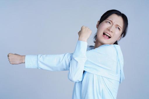 水色の服の女性が笑顔で腕を広げる 女性,腕を伸ばす,ストレッチの写真素材