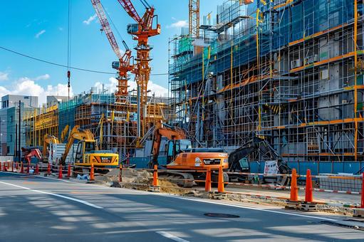 タワークレーンと掘削機が並ぶ都市建設現場 タワークレーンと掘削機が並ぶ都市建設現場の写真