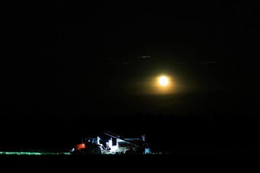 夜に作業するトラクター トラクター,夜,満月の写真素材