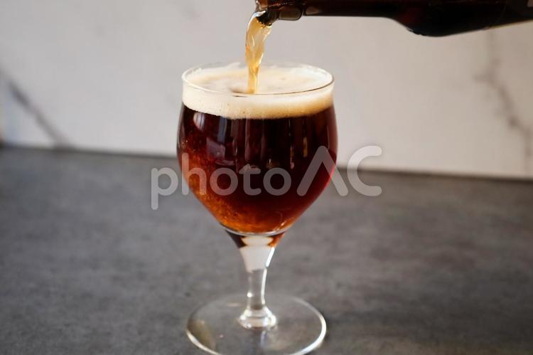 黒ビールを注いでいる写真 黒ビール,ワイングラス,晩酌の写真素材
