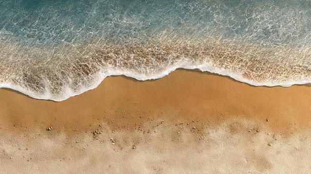 砂浜に打ち寄せる波 砂浜に打ち寄せる波の写真