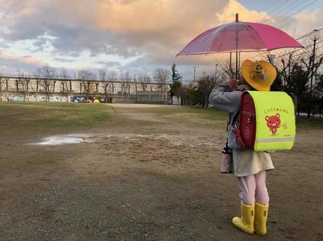 First grader looking up at the sky after rain First grader looking up at the sky after rain