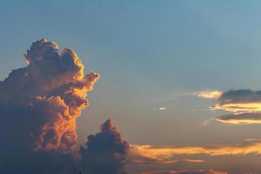 Golden cumulonimbus clouds illuminated by the setting sun, JPG
