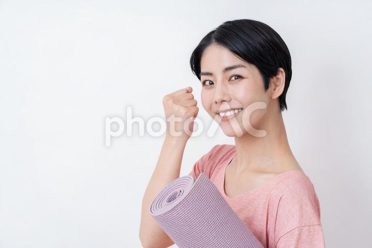 ガッツポーズのヨガインストラクターの女性 ガッツポーズ,ヨガ,フィットネスの写真素材