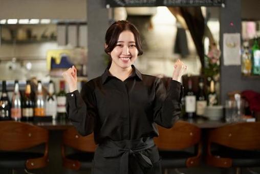 Asian female doing a guts pose at a restaurant Asian female doing a guts pose at a restaurant