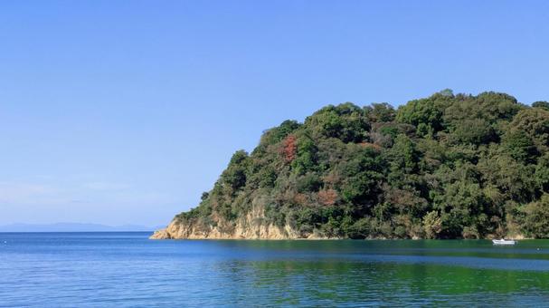 青空と緑の岬、静かなる入り江 今治市,大西町,鴨池海岸の写真素材