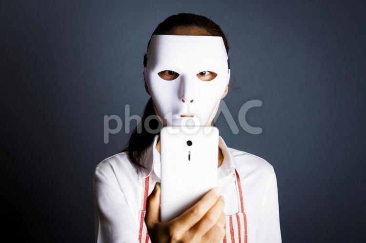 スマホ・犯罪イメージ 人物,女性,仮面の写真素材