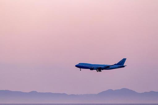 Passenger plane silhouette flying in the pink sunset sky, JPG Passenger plane silhouette flying in the pink sunset sky, JPG