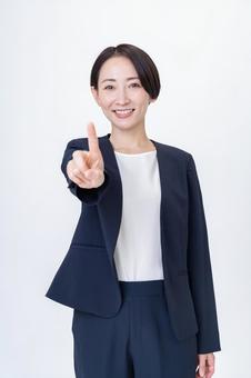 指を立ててポイントを示すスーツ姿の女性 ナンバーワン,ビジネス,女性の写真素材
