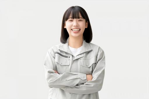 作業服を着て腕組みをする若い女性 作業服を着て腕組みをする若い女性 女性,ビジネス,作業服の写真素材