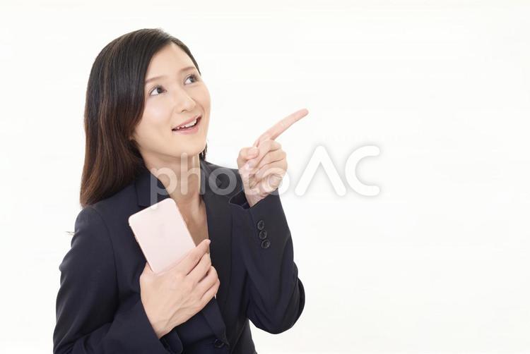 スマートフォンを持つ笑顔の女性 女性,ビジネスウーマン,女の写真素材
