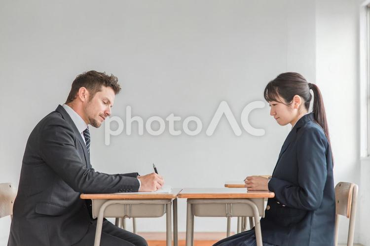 学校で二者面談を行う教師と高校生（悩む） 成績,生徒指導,怒られるの写真素材