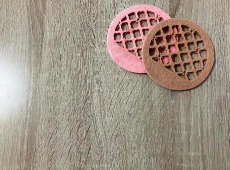 A pair of pink and brown round coasters, JPG