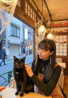 黒猫と女性が過ごすハロウィン猫カフェ 黒猫と女性が過ごすハロウィン猫カフェの写真