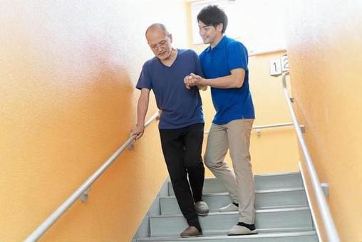 Elderly people going down the stairs with assistance Elderly people going down the stairs with assistance