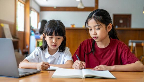 夏休み、勉強をする女子小学生・中学生の写真