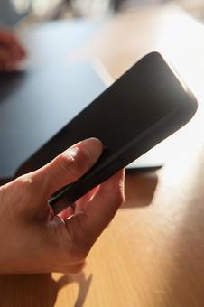 スマートフォンを持つ男性の手元_縦 スマートフォン,スマホ,携帯電話の写真素材