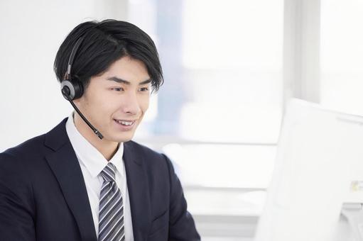 Call center man responding with a smile, JPG Call center man responding with a smile, teleoper, a smile, male, JPG